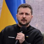 Winter Crisis: Zelensky Slams Kyiv Readiness man holding a microphone during a talk
