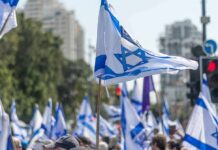 Knife-Edge Standoff Freezes Israel Israeli flags waved at a street demonstration
