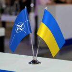 NATO and Ukraine table flags on a small metal stand