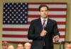 Open CIA Pitch Rattles Cuba man in suit speaking into a microphone