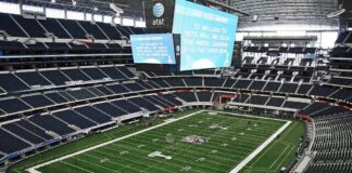 American football stadium interior with large central video board