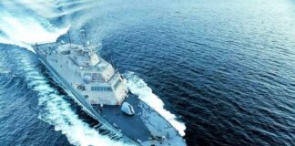 Naval warship cutting through open sea